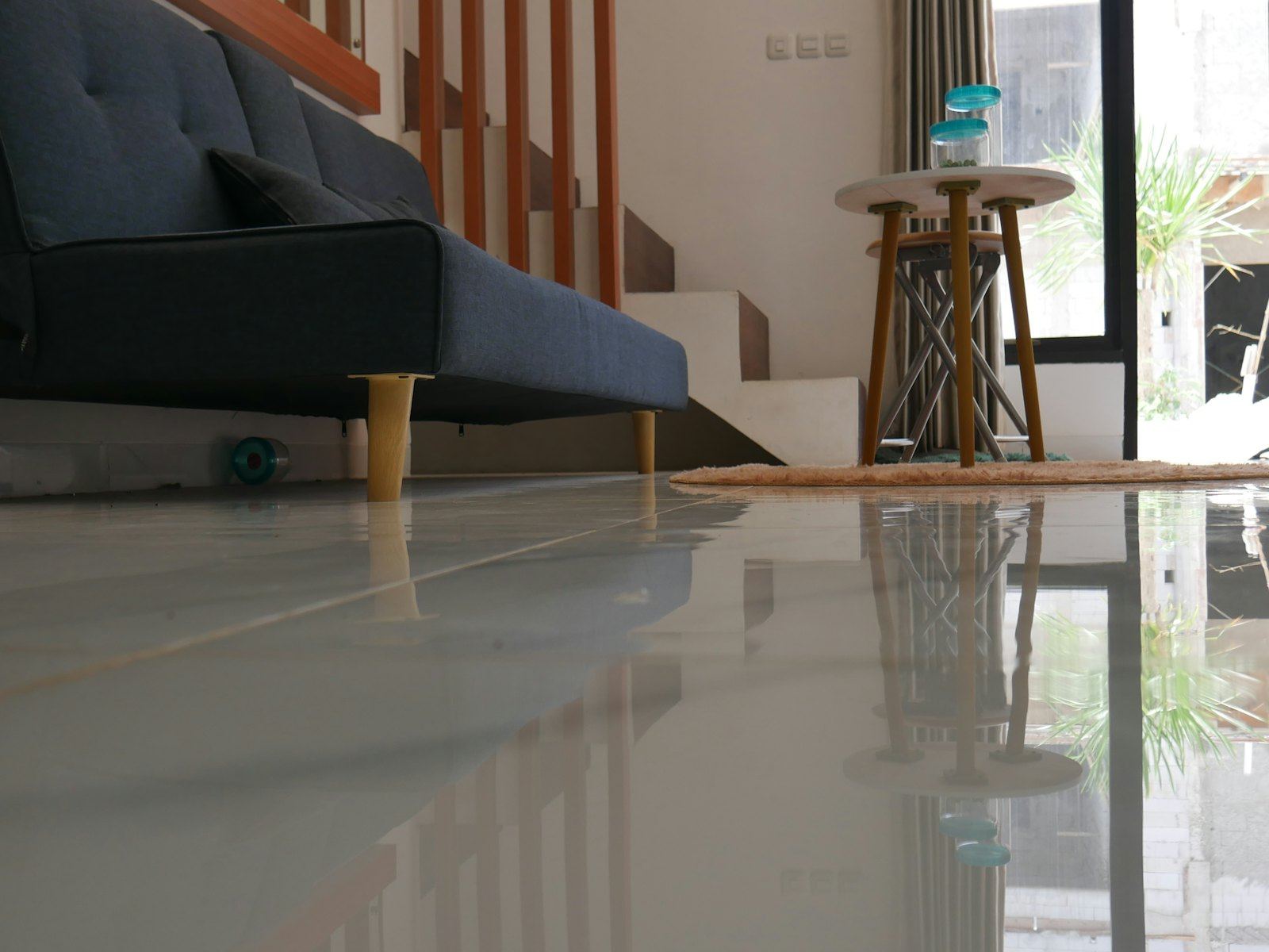 Living room interior with sofa and glossy floor