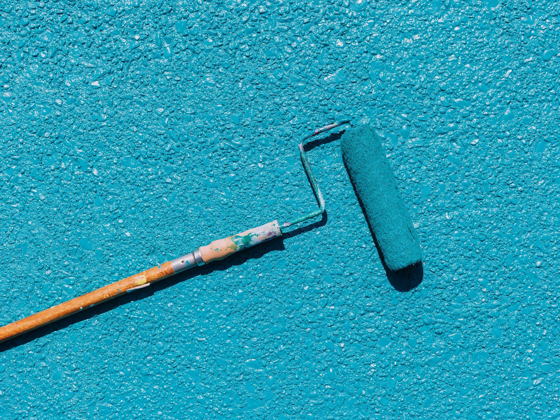 Close-up of a paint roller on a textured surface