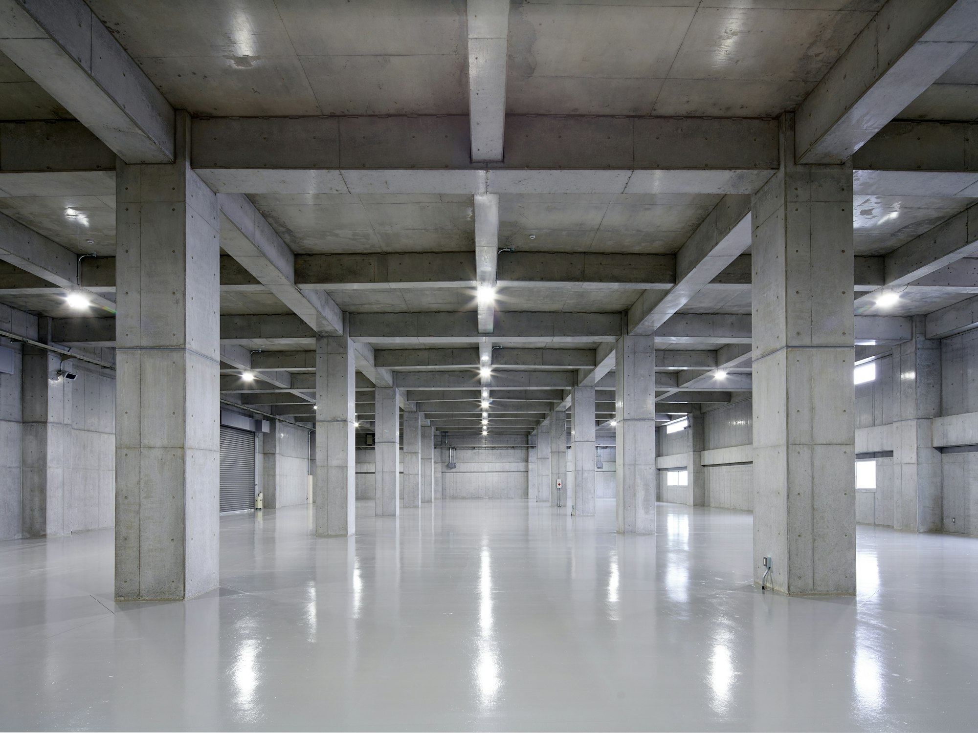 Empty concrete parking garage with rows of pillars