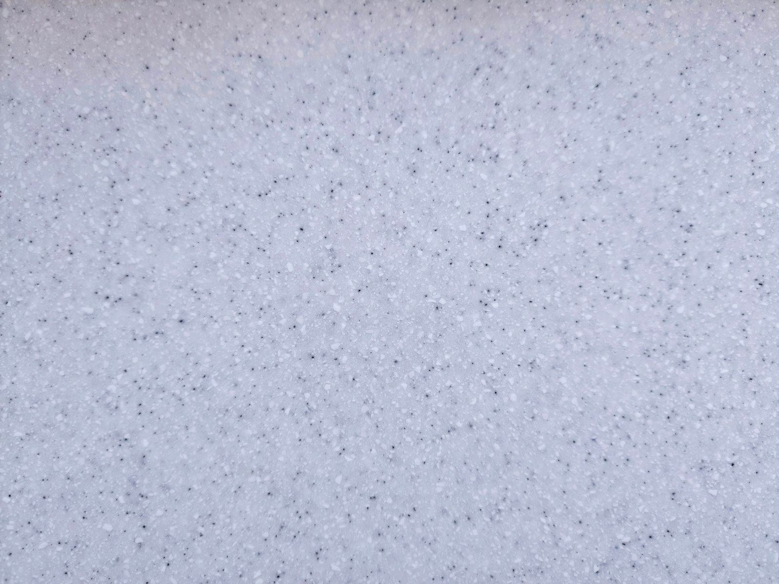 Close-up of a light blue speckled resin floor surface