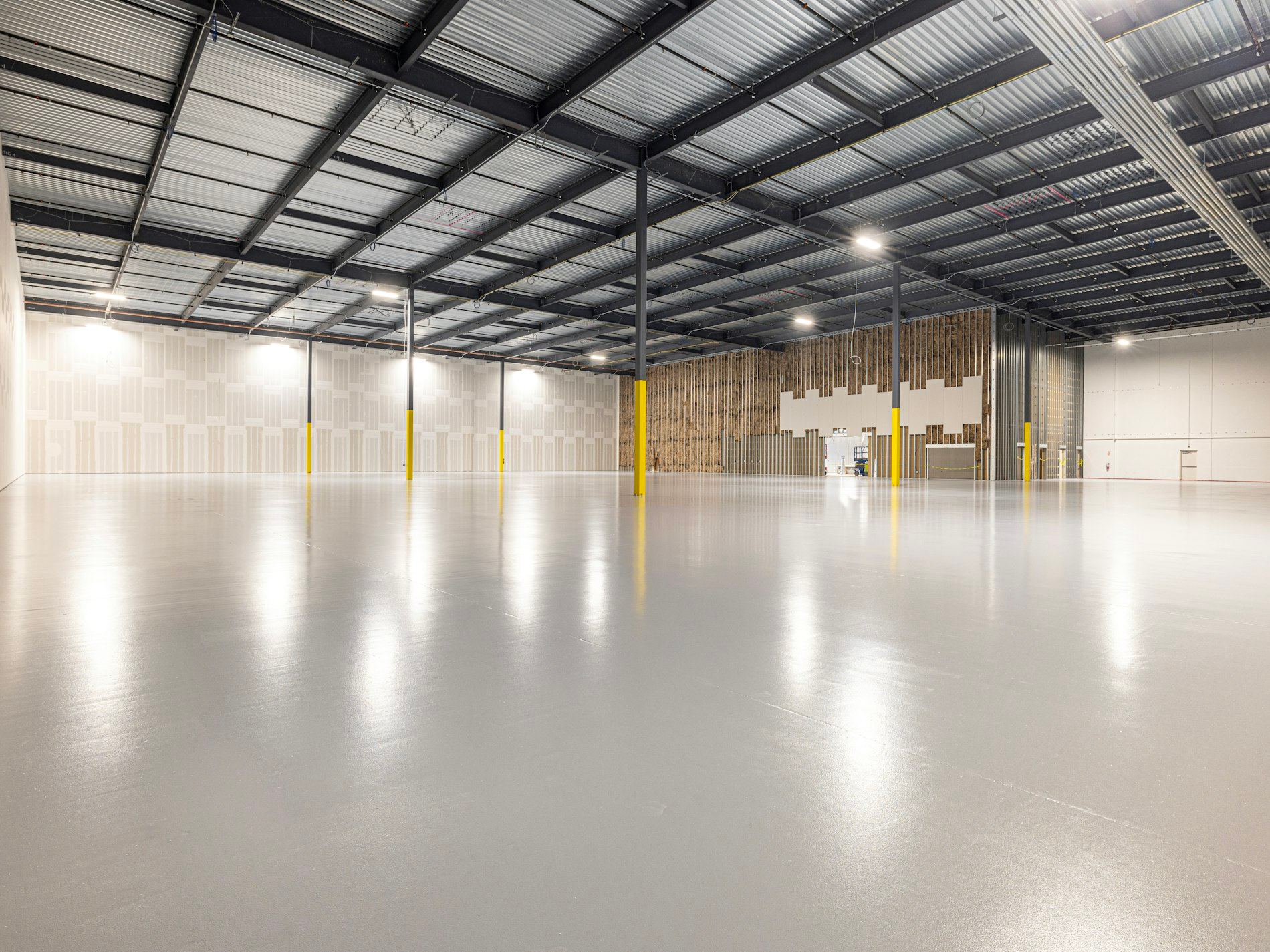Empty warehouse with glossy polished resin floor and natural light